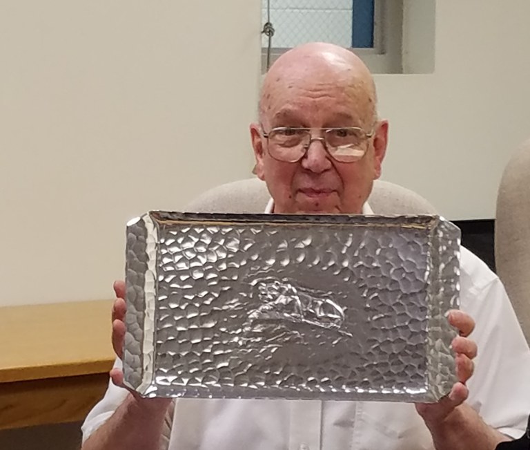 Dr. Lester Griel holding his gift for 53 years of service to Penn State